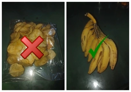 A close-up of plastic bags containing bananas and potato chips