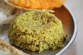 A plate featuring donne biryani, bread, and various other food items arranged attractively for a meal.
